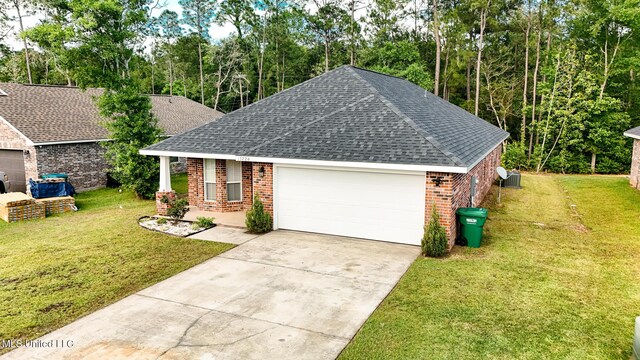 13724 Fox Hill Dr, Gulfport, MS 39503 - view of front of house featuring a shingled roof, brick siding, a garage, and a front yard
