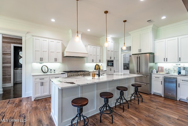 29 Club Dr, Natchez, MS 39120 - kitchen featuring white cabinetry, a breakfast bar area, stainless steel appliances, beverage cooler, and visible vents