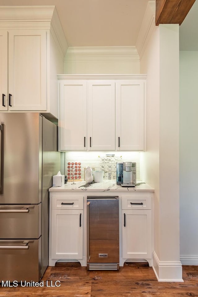 29 Club Dr, Natchez, MS 39120 - bar with freestanding refrigerator, ornamental molding, dark wood-style floors, and decorative backsplash