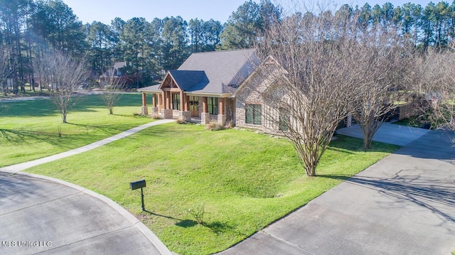29 Club Dr, Natchez, MS 39120 - view of front of home with driveway, stone siding, and a front yard