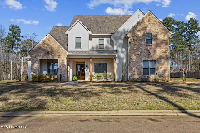 view of front of property featuring brick siding, board and batten siding, and a front lawn