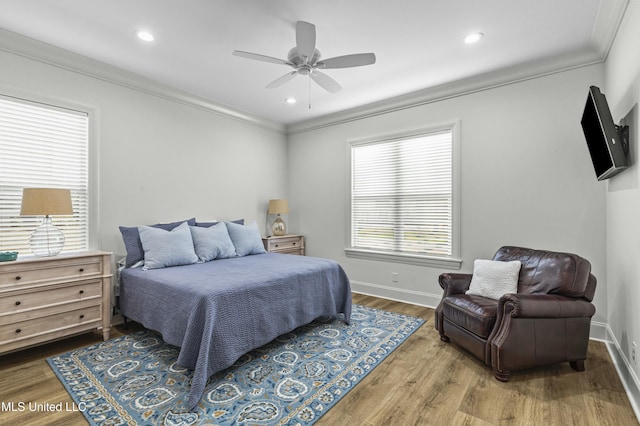 bedroom featuring recessed lighting, wood finished floors, baseboards, and ornamental molding