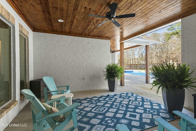 view of patio featuring an outdoor pool and a ceiling fan