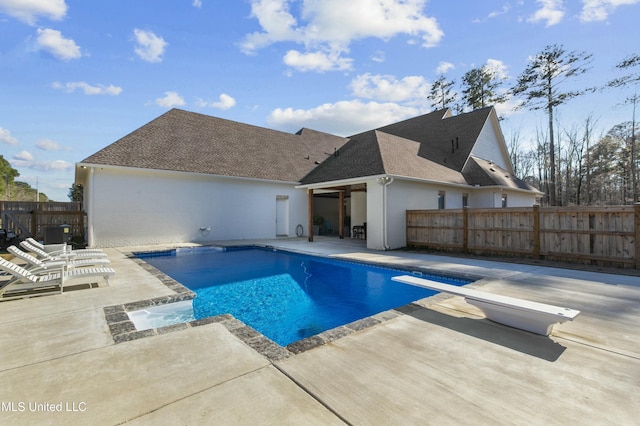 view of pool with a patio, a fenced in pool, fence, a diving board, and central AC