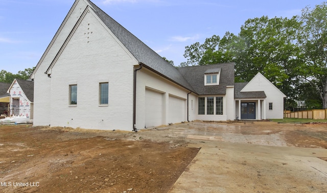 230 Parke Dr, Ridgeland, MS 39157 - exterior space featuring brick siding, a shingled roof, an attached garage, and concrete driveway