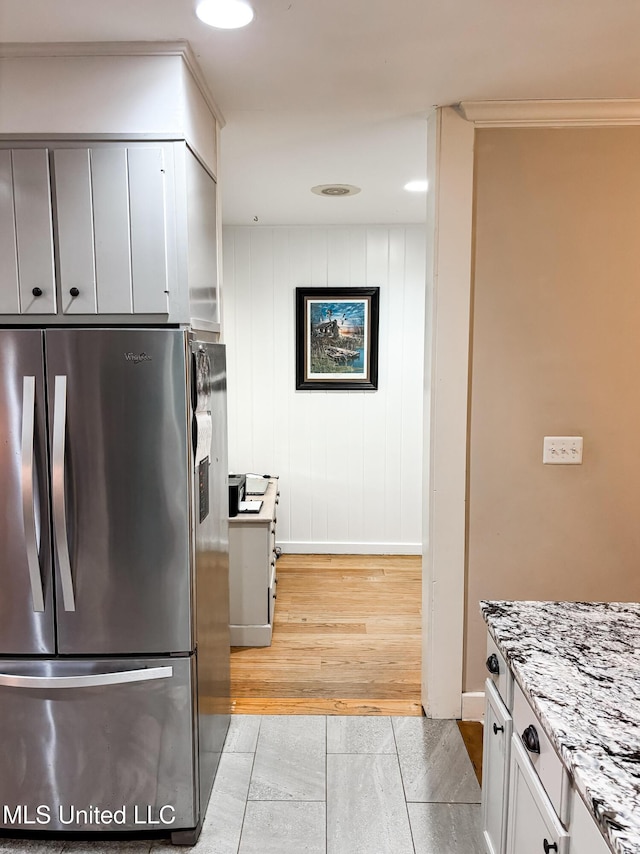503 E Adams Ave, Greenwood, MS 38930 - kitchen with freestanding refrigerator, baseboards, and light stone countertops
