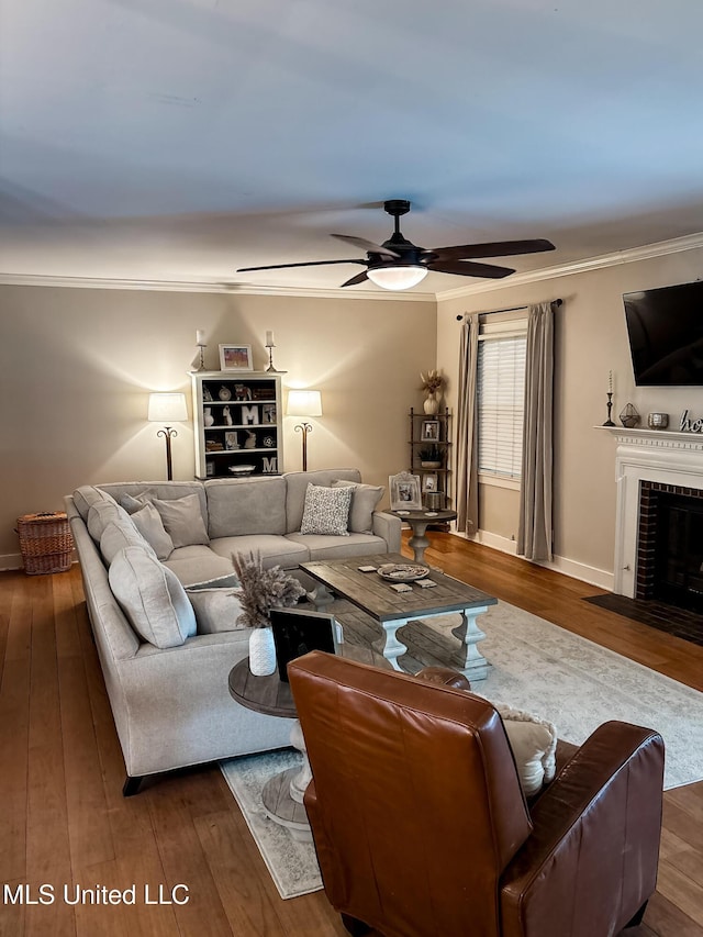 503 E Adams Ave, Greenwood, MS 38930 - living area with ornamental molding, wood finished floors, ceiling fan, a fireplace, and baseboards