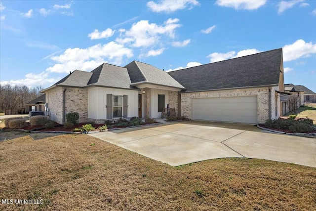 view of front of home with brick siding, an attached garage, and driveway