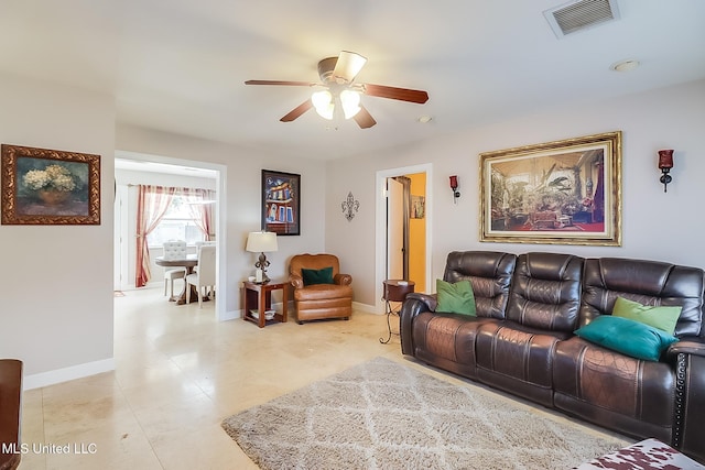 tiled living room featuring ceiling fan