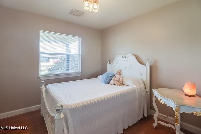 bedroom with dark hardwood / wood-style flooring