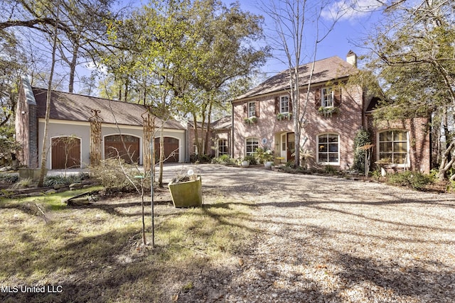 view of property's community with driveway and an attached garage