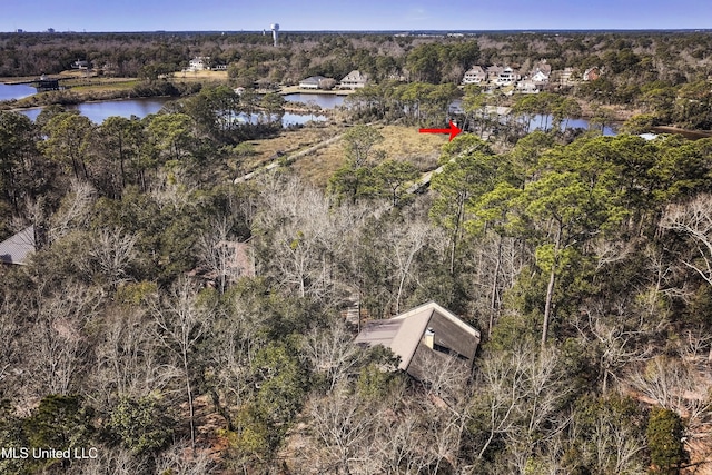 aerial view with a forest view and a water view