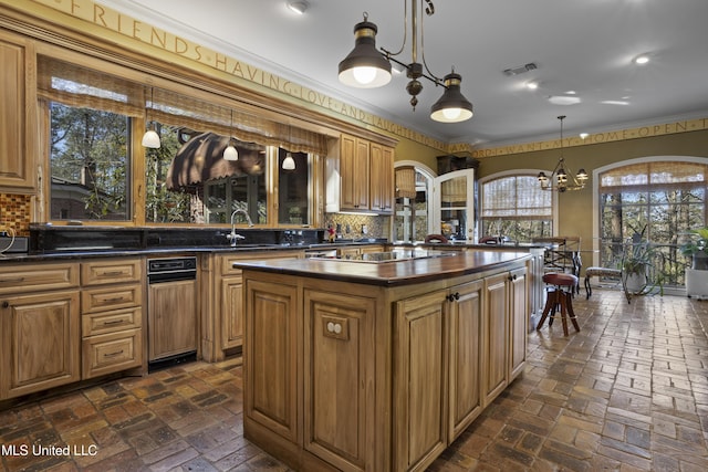 kitchen featuring dark countertops, black electric cooktop, brick floor, and backsplash