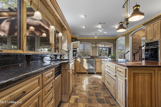 kitchen featuring wooden counters, crown molding, arched walkways, black appliances, and a sink