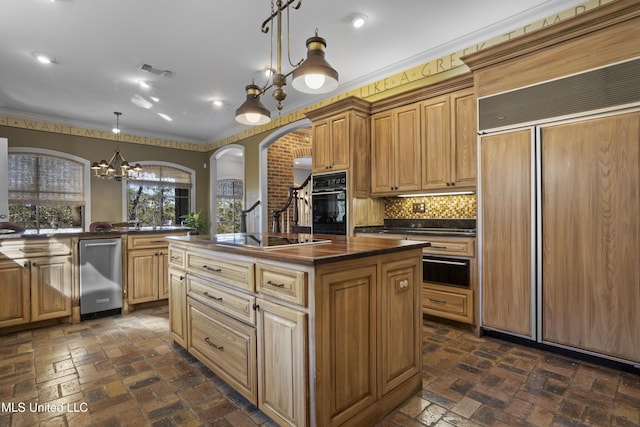 kitchen featuring black appliances, brick floor, visible vents, and backsplash
