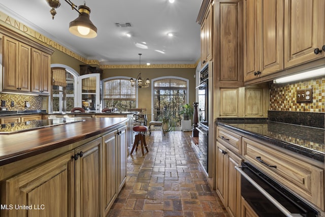 kitchen with visible vents, crown molding, butcher block counters, brick floor, and a warming drawer