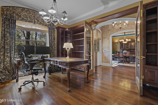 home office with crown molding, baseboards, a chandelier, hardwood / wood-style flooring, and arched walkways