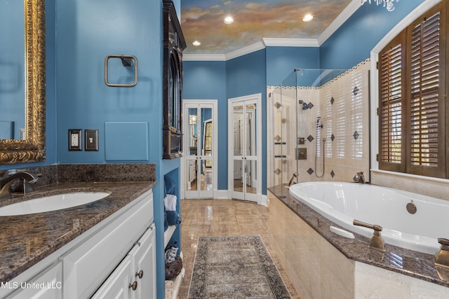 full bath with a garden tub, a shower stall, crown molding, baseboards, and vanity