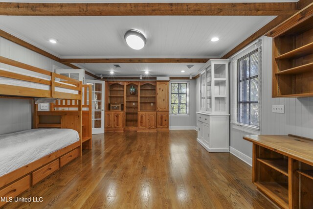 bedroom with dark wood-style floors, crown molding, and baseboards