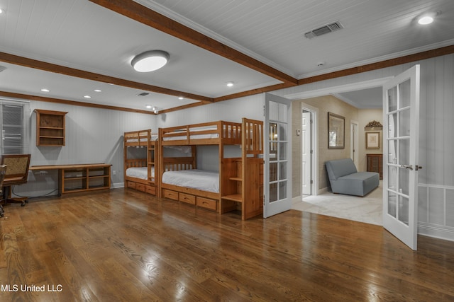 bedroom featuring french doors, beamed ceiling, wood finished floors, and visible vents