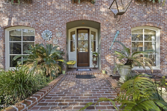 property entrance featuring brick siding