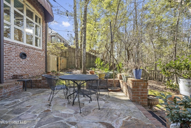view of patio with outdoor dining area and a fenced backyard