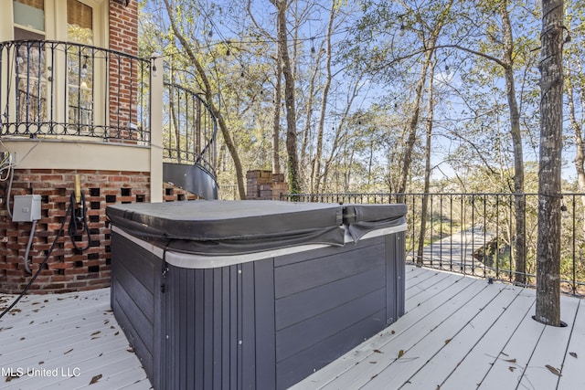 wooden terrace with a hot tub