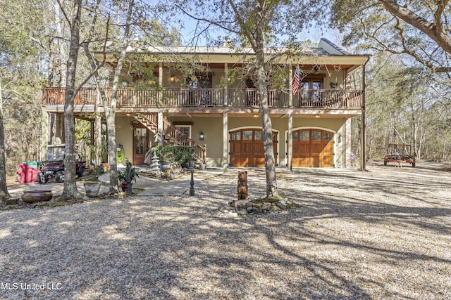 view of front of property featuring stairs and stucco siding