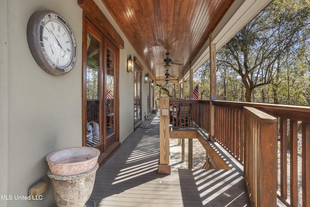 deck with french doors and a ceiling fan