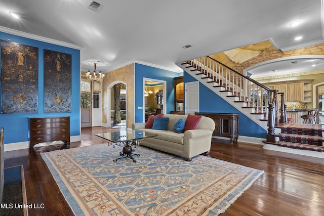 living room featuring stairs, crown molding, visible vents, and hardwood / wood-style floors