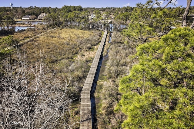 aerial view with a water view and a wooded view