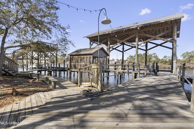 view of dock with boat lift and a water view