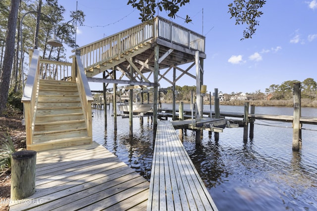 dock area with boat lift and a water view