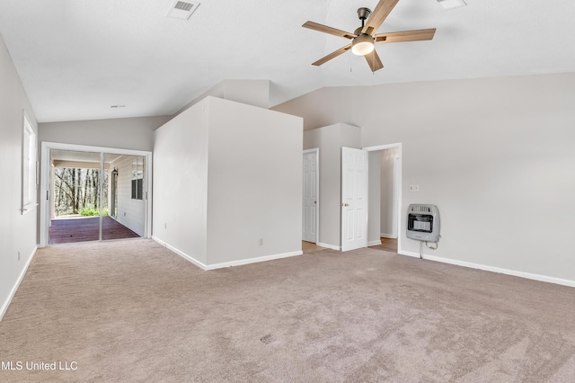 carpeted spare room with lofted ceiling, heating unit, baseboards, and visible vents