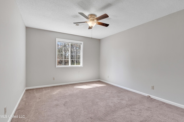 unfurnished room featuring visible vents, a ceiling fan, a textured ceiling, carpet, and baseboards