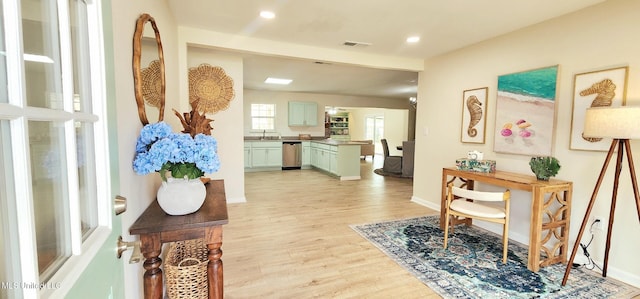 hallway with baseboards, light wood-type flooring, visible vents, and recessed lighting