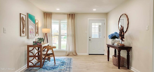 entryway with recessed lighting, baseboards, and light wood finished floors