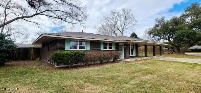 ranch-style house featuring driveway, brick siding, a carport, and a front yard