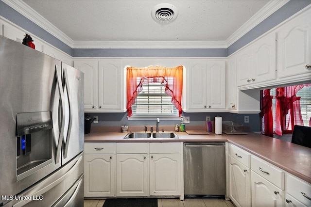 5967 Huntview Dr, Jackson, MS 39206 - kitchen featuring stainless steel appliances, a sink, white cabinets, and ornamental molding