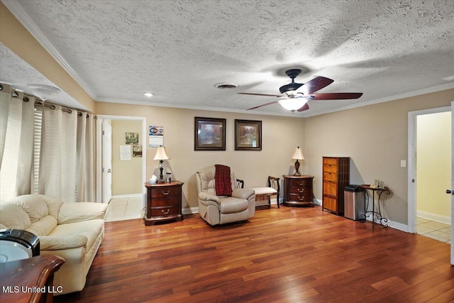 5967 Huntview Dr, Jackson, MS 39206 - living room featuring wood finished floors, a ceiling fan, crown molding, baseboards, and a textured ceiling