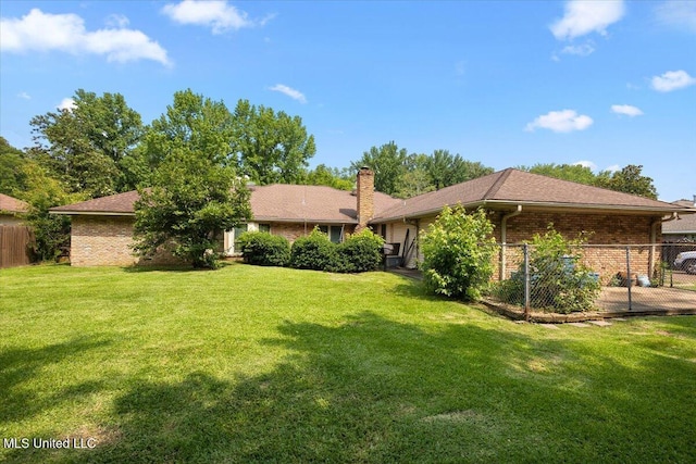 5967 Huntview Dr, Jackson, MS 39206 - rear view of house with brick siding and a chimney