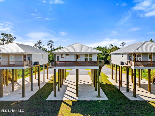 rear view of house with a yard and a carport