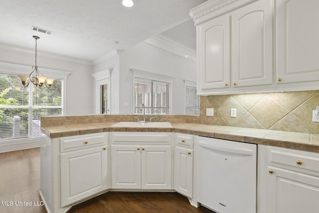 144 Whisper Lake Blvd, Madison, MS 39110 - kitchen featuring dishwasher, a peninsula, crown molding, dark wood-style floors, and a chandelier