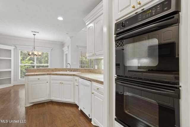 144 Whisper Lake Blvd, Madison, MS 39110 - kitchen with white dishwasher, a peninsula, a chandelier, tile countertops, and decorative backsplash