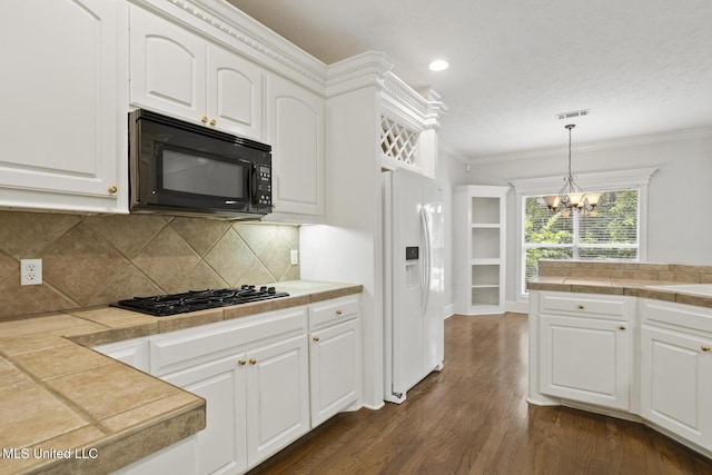144 Whisper Lake Blvd, Madison, MS 39110 - kitchen with black appliances, ornamental molding, a chandelier, dark wood-type flooring, and white cabinetry