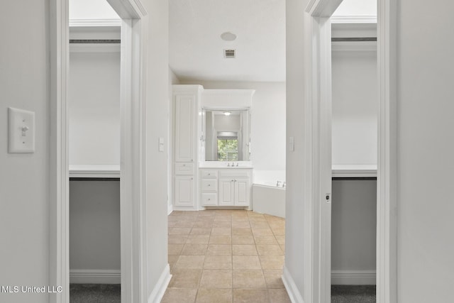 144 Whisper Lake Blvd, Madison, MS 39110 - corridor featuring a sink and light tile patterned floors