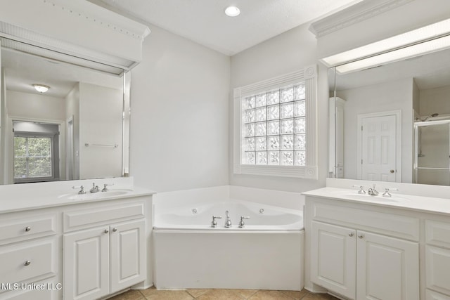 144 Whisper Lake Blvd, Madison, MS 39110 - bathroom with two vanities, a bath, a stall shower, and tile patterned flooring