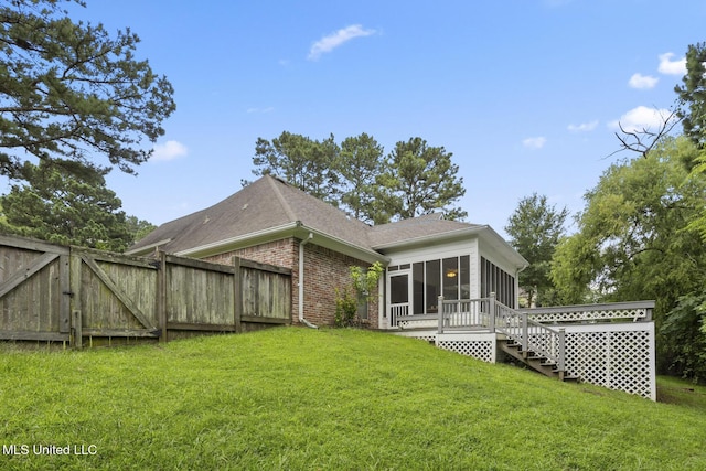 144 Whisper Lake Blvd, Madison, MS 39110 - back of house featuring a sunroom, brick siding, a shingled roof, and a gate