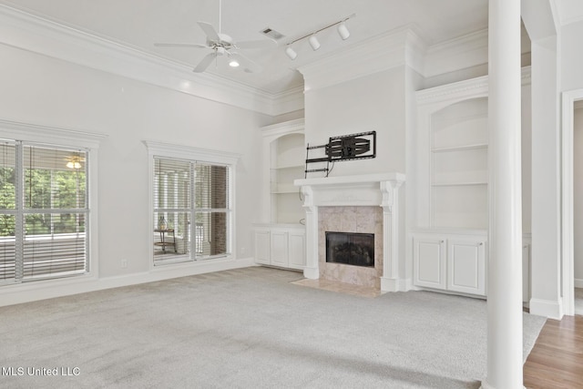 144 Whisper Lake Blvd, Madison, MS 39110 - unfurnished living room with a ceiling fan, a fireplace, track lighting, crown molding, and carpet flooring