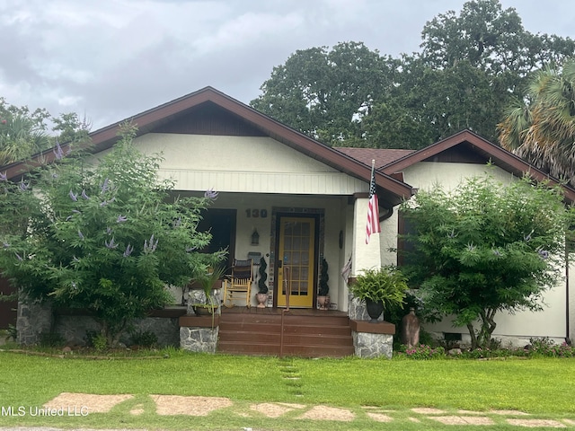 view of front of home featuring a porch and a front lawn